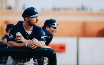 Baseball player holding 2 baseballs
