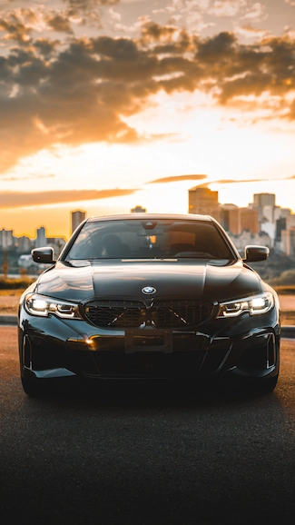 Shot of BMW car with cityscape and sunset