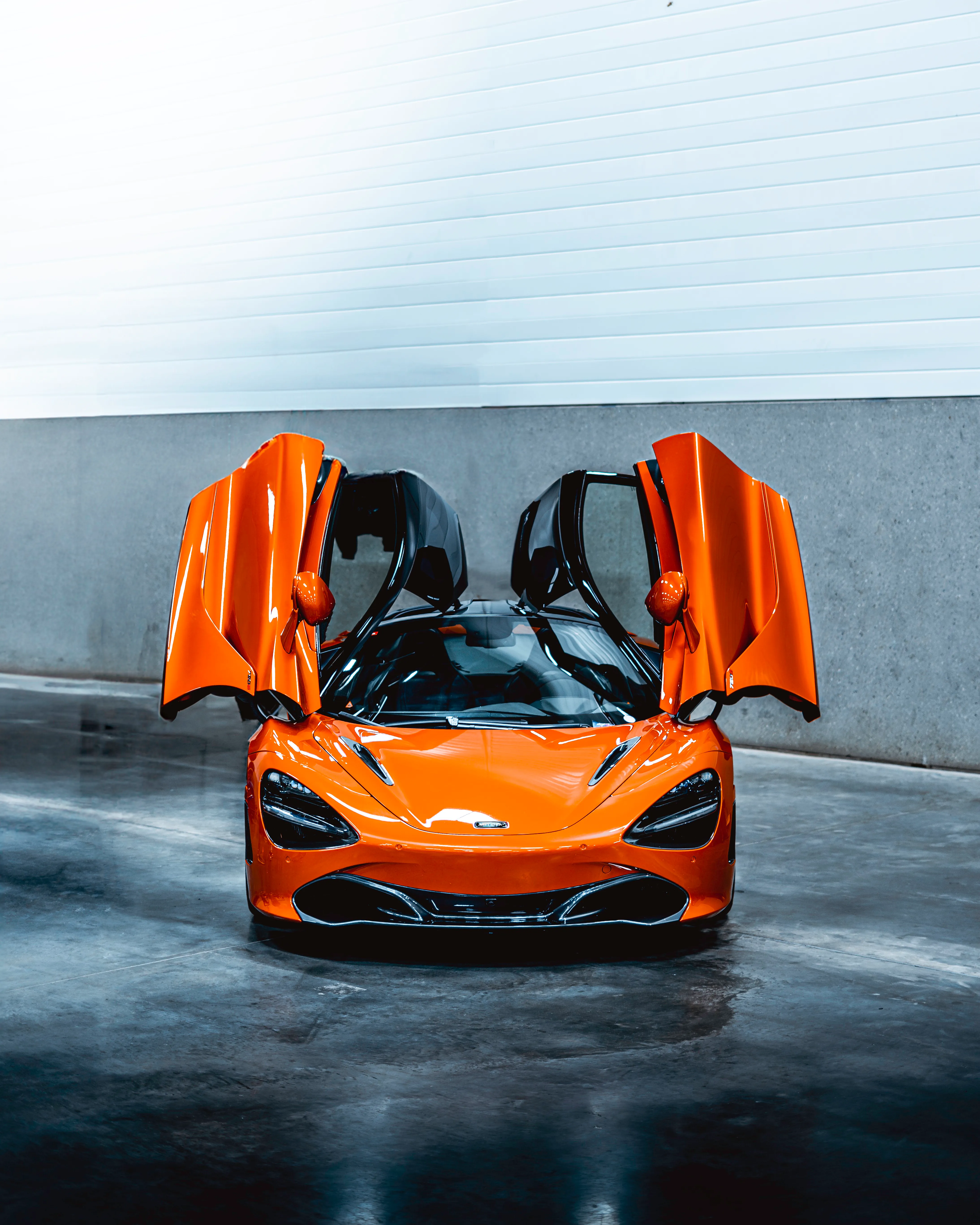 Orange Mclaren with butterfly doors open