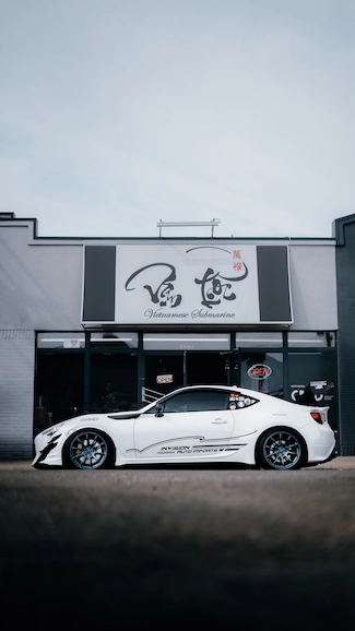 Toyota Supra parked in front of Vietnamese restaurant